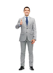 Image showing happy businessman in suit showing thumbs up