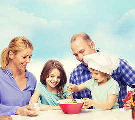 Image showing happy family with two kids eating at home