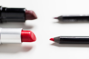 Image showing close up of two open lipsticks and lip pencils