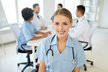 Image showing happy doctor over group of medics at hospital