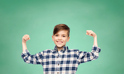 Image showing happy boy in checkered shirt showing strong fists