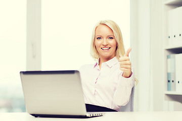 Image showing smiling businesswoman or student with laptop