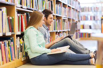 Image showing happy students with laptop in library