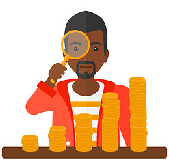 Image showing Man with magnifier and golden coins. 