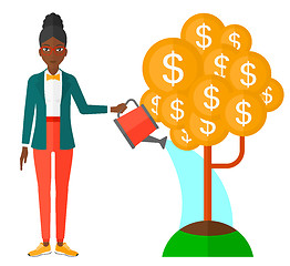 Image showing Woman watering money tree.