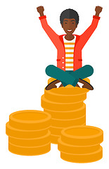 Image showing  Happy businessman sitting on coins.