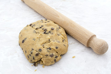 Image showing Chocolate chip cookie dough with a rolling pin