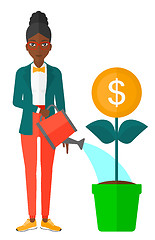 Image showing Woman watering money tree.