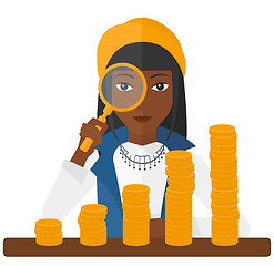 Image showing Woman with magnifier and golden coins. 