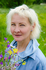 Image showing Portrait of woman with a bouquet of wildflowers in your hand