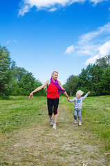 Image showing A woman with a child on the sports outing