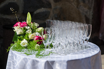 Image showing Bouquet of flowers and wine glasses for a wedding table 