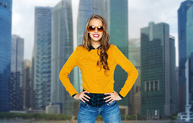 Image showing happy young woman or teen girl in shades over city