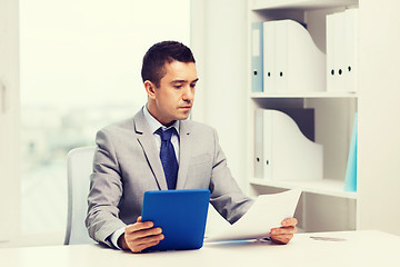 Image showing businessman with tablet pc and papers in office