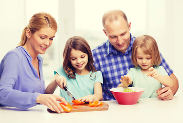 Image showing happy family with two kids making dinner at home