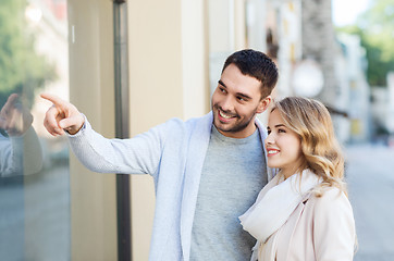 Image showing happy couple shopping and looking at shop window