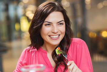 Image showing happy young woman having dinner at restaurant
