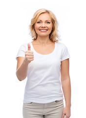 Image showing smiling woman in white t-shirt showing thumbs up