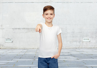 Image showing happy boy in white t-shirt pointing finger to you