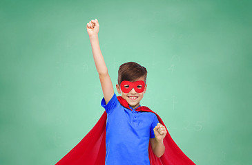 Image showing boy in red superhero cape and mask showing fists