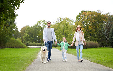 Image showing happy family with labrador retriever dog in park