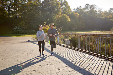 Image showing happy couple running outdoors