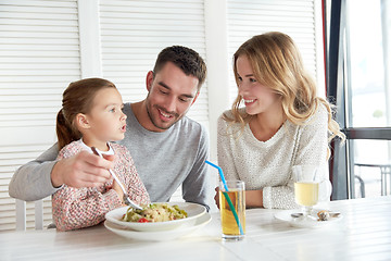 Image showing happy family having dinner at restaurant or cafe