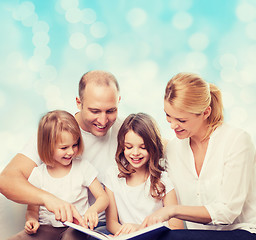 Image showing happy family with book at home