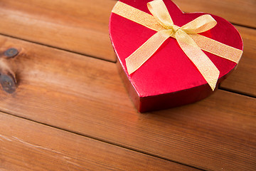 Image showing close up of heart shaped gift box on wood