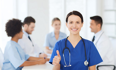 Image showing happy doctor over group of medics at hospital