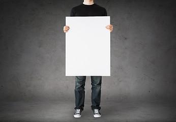 Image showing close up of man holding big blank white board