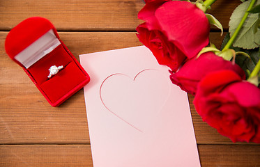 Image showing close up of diamond ring, roses and greeting card