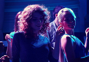 Image showing group of happy friends dancing in night club