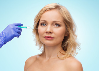 Image showing woman face and beautician hand with syringe