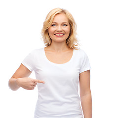 Image showing smiling woman in white t-shirt pointing to herself