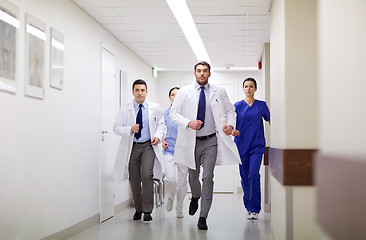 Image showing group of medics walking along hospital