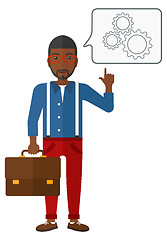 Image showing Businessman pointing at cogwheels.