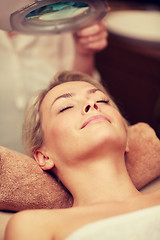 Image showing close up of young woman lying in spa