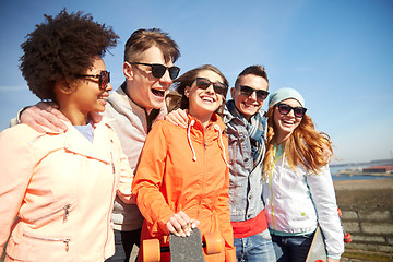 Image showing happy teenage friends with longboards on street