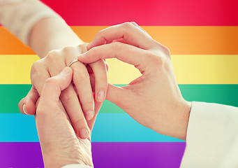 Image showing close up of lesbian couple hands with wedding ring