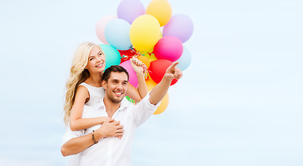 Image showing couple with colorful balloons at sea side