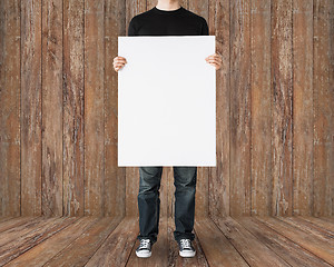 Image showing close up of man holding big blank white board