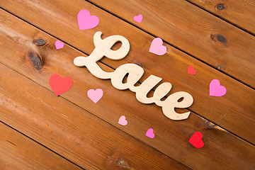 Image showing close up of word love with red paper hearts
