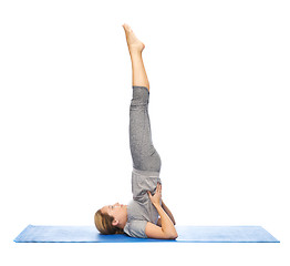 Image showing woman making yoga in shoulderstand pose on mat