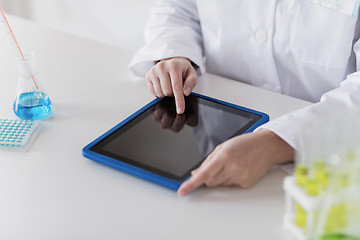 Image showing close up of scientist with tablet pc in lab