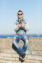 Image showing happy young man with tablet pc and headphones