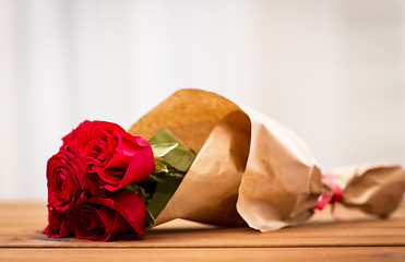 Image showing close up of red roses bunch wrapped into paper