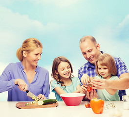 Image showing happy family with two kids making dinner at home