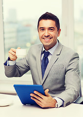 Image showing smiling businessman with tablet pc and coffee cup