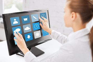 Image showing businesswoman with computer touchscreen in office